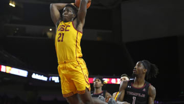 LOS ANGELES, CA - NOVEMBER 22: Onyeka Okongwu #21 of the USC Trojans gets past Quinton Rose #1 of the Temple Owls for a dunk in the second half at Galen Center on November 22, 2019 in Los Angeles, California. (Photo by John McCoy/Getty Images)