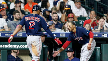 HOUSTON, TEXAS - MAY 24: Xander Bogaerts #2 of the Boston Red Sox receives congratulations from Mookie Betts #50 after hitting a home run in the sixth inning against the Houston Astros at Minute Maid Park on May 24, 2019 in Houston, Texas. (Photo by Bob Levey/Getty Images)