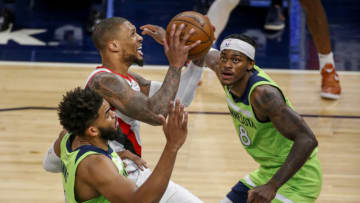 Portland Trail Blazers guard Damian Lillard shoots between Minnesota Timberwolves center Karl-Anthony Towns and forward Jarred Vanderbilt. Mandatory Credit: Bruce Kluckhohn-USA TODAY Sports