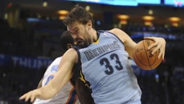 May 3, 2014; Oklahoma City, OK, USA; Memphis Grizzlies center Marc Gasol (33) drives to the basket against Oklahoma City Thunder forward Serge Ibaka (9) during the second quarter in game seven of the first round of the 2014 NBA Playoffs at Chesapeake Energy Arena. Mandatory Credit: Mark D. Smith-USA TODAY Sports