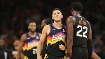 PHOENIX, ARIZONA - OCTOBER 20: Devin Booker #1of the Phoenix Suns high fives Deandre Ayton #22 after scoring against the Denver Nuggets during the first half of the NBA game at Footprint Center on October 20, 2021 in Phoenix, Arizona. NOTE TO USER: User expressly acknowledges and agrees that, by downloading and or using this photograph, User is consenting to the terms and conditions of the Getty Images License Agreement. (Photo by Christian Petersen/Getty Images)