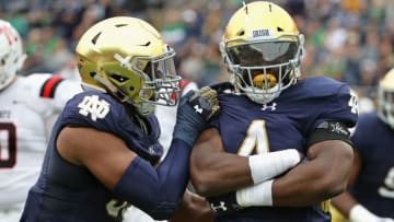 SOUTH BEND, IN - SEPTEMBER 08: Te'von Coney #4 of the Notre Dame Fighting Irish celebrates a sack with Khalid Kareem #53 against the Ball State Cardinals at Notre Dame Stadium on September 8, 2018 in South Bend, Indiana. (Photo by Jonathan Daniel/Getty Images)