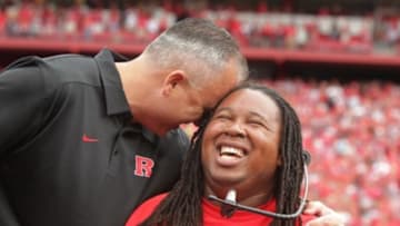 Sep 14, 2013; Piscataway, NJ, USA; Rutgers Scarlet Knights former player Eric LeGrand (right) is greeted by head coach Kyle Flood during halftime of a game against the Eastern Michigan Eagles for his jersey number retirement ceremony at High Points Solutions Stadium. Mandatory Credit: John O