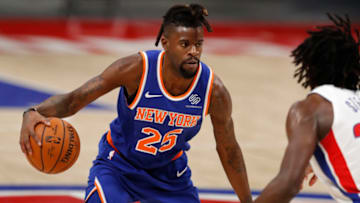 Dec 11, 2020; Detroit, Michigan, USA; New York Knicks forward Reggie Bullock (25) gets defended by Detroit Pistons center Isaiah Stewart (28) during the fourth quarter at Little Caesars Arena. Mandatory Credit: Raj Mehta-USA TODAY Sports