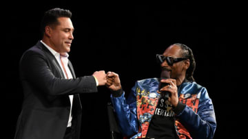 LAS VEGAS, NEVADA - MARCH 26: Golden Boy Promotions Chairman and CEO Oscar De La Hoya (L) is greeted onstage by rapper Snoop Dogg during a news conference for Triller Fight Club's inaugural 2021 boxing event at The Venetian Las Vegas on March 26, 2021 in Las Vegas, Nevada. The event will take place on April 17, 2021, at Mercedes-Benz Stadium in Atlanta. De La Hoya announced that he will make his return to boxing on July 3, 2021. (Photo by Ethan Miller/Getty Images)