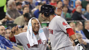 TORONTO, ON - APRIL 26: J.D. Martinez #28 of the Boston Red Sox is congratulated by Mookie Betts #50 after hitting a three-run home run in the fifth inning during MLB game action against the Toronto Blue Jays at Rogers Centre on April 26, 2018 in Toronto, Canada. (Photo by Tom Szczerbowski/Getty Images)