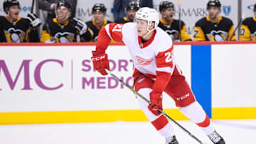 PITTSBURGH, PA - SEPTEMBER 23: Detroit Red Wings defenseman Dennis Cholowski (21) handles the puck on the point during the third period in the preseason game between the Pittsburgh Penguins and the Detroit Red Wings on September 23, 2018, at PPG Paints Arena in Pittsburgh, PA.The Detroit Red Wings defeated the Pittsburgh Penguins 3-2. (Photo by Jeanine Leech/Icon Sportswire via Getty Images)