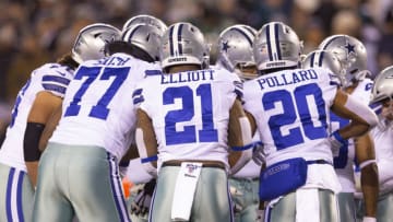 PHILADELPHIA, PA - DECEMBER 22: Tyron Smith #77, Ezekiel Elliott #21, and Tony Pollard #20 of the Dallas Cowboys huddle against the Philadelphia Eagles at Lincoln Financial Field on December 22, 2019 in Philadelphia, Pennsylvania. (Photo by Mitchell Leff/Getty Images)