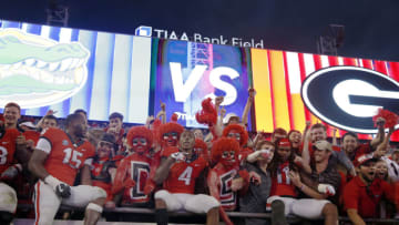 Georgia Bulldogs wide receiver Mecole Hardman (4) celebrates with teammates and fans after defeating the Florida Gators at TIAA Bank Field. Mandatory Credit: Kim Klement-USA TODAY Sports