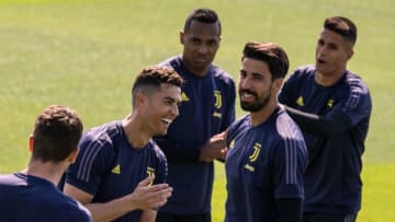 Juventus' Portuguese forward Cristiano Ronaldo (2nd L) share a laugh with teammates during a training session on the eve of the UEFA Champions League football match Ajax vs Juventus on April 9, 2019 at the Juventus Training Center in Turin. (Photo by MARCO BERTORELLO / AFP) (Photo credit should read MARCO BERTORELLO/AFP via Getty Images)