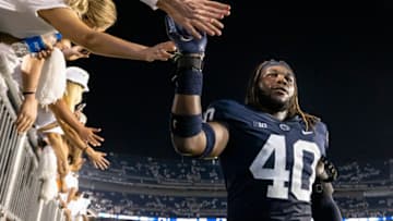 STATE COLLEGE, PA - SEPTEMBER 18: Jesse Luketa #40 of the Penn State Nittany Lions celebrates with fans after the game against the Auburn Tigers at Beaver Stadium on September 18, 2021 in State College, Pennsylvania. (Photo by Scott Taetsch/Getty Images)