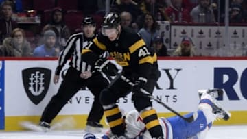 Jan 19, 2016; Montreal, Quebec, CAN; Montreal Canadiens defenseman Alexei Emelin (74) dives for the puck to take it away from Boston Bruins forward Joonas Kemppainen (41) during the first period at the Bell Centre. Mandatory Credit: Eric Bolte-USA TODAY Sports
