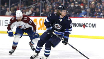 Apr 24, 2022; Winnipeg, Manitoba, CAN; Winnipeg Jets left wing Kyle Connor (81) skates past Colorado Avalanche right wing Valeri Nichushkin (13) in the second period at Canada Life Centre. Mandatory Credit: James Carey Lauder-USA TODAY Sports