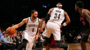 Mar 10, 2014; Brooklyn, NY, USA; Brooklyn Nets point guard Deron Williams (8) drives to the basket against the Toronto Raptors during the fourth quarter at the Barclays Center. The Brooklyn Nets defeated the Toronto Raptors 101-97. Mandatory Credit: Adam Hunger-USA TODAY Sports
