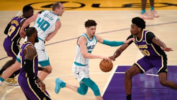 LOS ANGELES, CALIFORNIA - MARCH 18: LaMelo Ball #2 of the Charlotte Hornets dribbles in front of Damian Jones #30 of the Los Angeles Lakers during the first quarter at Staples Center on March 18, 2021 in Los Angeles, California. (Photo by Harry How/Getty Images) NOTE TO USER: User expressly acknowledges and agrees that, by downloading and or using this photograph, User is consenting to the terms and conditions of the Getty Images License Agreement.