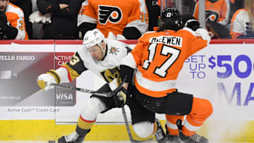 Mar 8, 2022; Philadelphia, Pennsylvania, USA; Philadelphia Flyers center Zack MacEwen (17) checks Vegas Golden Knights right wing Evgenii Dadonov (63) during the third period at Wells Fargo Center. Mandatory Credit: Eric Hartline-USA TODAY Sports