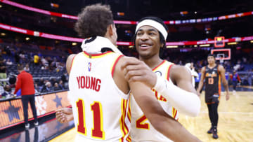 ORLANDO, FLORIDA - DECEMBER 15: Trae Young #11 and Sharife Cooper #2 of the Atlanta Hawks celebrate after defeating the Orlando Magic at Amway Center on December 15, 2021 in Orlando, Florida. NOTE TO USER: User expressly acknowledges and agrees that, by downloading and or using this photograph, User is consenting to the terms and conditions of the Getty Images License Agreement. (Photo by Michael Reaves/Getty Images)