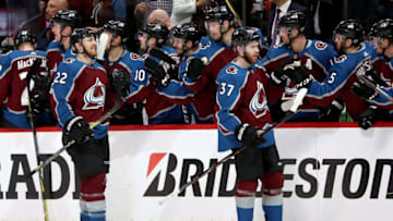 DENVER, CO - APRIL 16: Coilin Wilson #22 and J.T. Compher #37 of the Colorado Rockies celebrate their third goal against the Nashville Predators in Game Three of the Western Conference First Round during the 2018 NHL Stanley Cup Playoffs at the Pepsi Center on April 16, 2018 in Denver, Colorado. (Photo by Matthew Stockman/Getty Images)