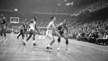 (Original Caption) Elgin Baylor, (right), of the Los Angeles Lakers, tries to maneuver the ball around Bob Cousy of the Boston Celtics during second half quarter action. Los Angeles won the fifth game of the NBA Championship 126-119.
