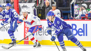 LAVAL, QC, CANADA - DECEMBER 14: Alex Barre-Boulet #12 of the Syracuse Crunch skating up the ice with Jake Evans #10 of the Laval Rocket right behind at Place Bell on December 14, 2018 in Laval, Quebec. (Photo by Stephane Dube /Getty Images)