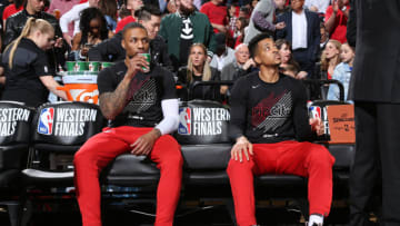 PORTLAND, OR - MAY 20: Damian Lillard #0 and CJ McCollum #3 of the Portland Trail Blazers look on before the game against the Golden State Warriors in Game Four of the Western Conference Finals on May 20, 2019 at the Moda Center in Portland, Oregon. NOTE TO USER: User expressly acknowledges and agrees that, by downloading and/or using this photograph, user is consenting to the terms and conditions of the Getty Images License Agreement. Mandatory Copyright Notice: Copyright 2019 NBAE (Photo by Sam Forencich/NBAE via Getty Images)
