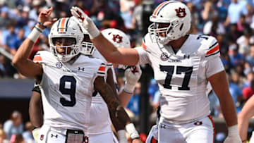 Auburn footballOct 15, 2022; Oxford, Mississippi, USA; Auburn Tigers quarterback Robby Ashford (9) reacts with offensive lineman Kilian Zierer (77) after a touchdown during the third quarter at Vaught-Hemingway Stadium. Mandatory Credit: Matt Bush-USA TODAY Sports