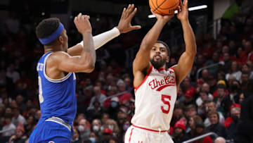 Cincinnati Bearcats guard David DeJulius shoots over Memphis Tigers forward Landers Nolley II at Fifth Third Arena. Getty Images.