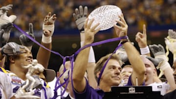 NEW ORLEANS - JANUARY 4: Head coach Nick Saban of the Loiusiana State Tigers holds up the Bowl Championship Series Trophy after his team defeated the Oklahoma Sooners in the Nokia Sugar Bowl National Championship on January 4, 2004 at the Louisiana Superdome in New Orleans, Louisiana. The Tigers defeated the Sooners 21-14 to win the National Championship. (Photo by Brian Bahr/Getty Images)