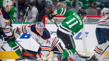 Nov 23, 2021; Dallas, Texas, USA; Edmonton Oilers goaltender Stuart Skinner (74) stops a shot by Dallas Stars center Luke Glendening (11) during the third period at the American Airlines Center. Mandatory Credit: Jerome Miron-USA TODAY Sports