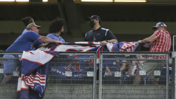 May 27, 2021; Bronx, New York, USA; Security removes a Donald Trump banner hung by two fans in the fourth inning during the game between the Toronto Blue Jays and the New York Yankees at Yankee Stadium. Mandatory Credit: Wendell Cruz-USA TODAY Sports