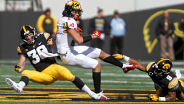 IOWA CITY, IOWA- OCTOBER 20: Defensive backs Jake Gervase #30 and Geno Stone #9 of the Iowa Hawkeyes get a stop during the second half on wide receiver Jahrvis Davenport #9 of the Maryland Terrapins on October 20, 2018 at Kinnick Stadium, in Iowa City, Iowa. (Photo by Matthew Holst/Getty Images)