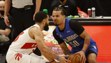 wJan 31, 2021; Tampa, Florida, USA; Orlando Magic guard Cole Anthony (50) drives to the basket as Toronto Raptors guard Fred VanVleet (23) defends during the first quarter at Amalie Arena. Mandatory Credit: Kim Klement-USA TODAY Sports