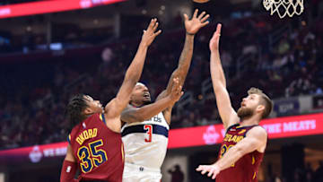 Nov 10, 2021; Cleveland, Ohio, USA; Washington Wizards guard Bradley Beal (3) drives between Cleveland Cavaliers forward Isaac Okoro (35) and forward Dean Wade (32) in the second quarter at Rocket Mortgage FieldHouse. Mandatory Credit: David Richard-USA TODAY Sports
