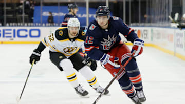 NEW YORK, NEW YORK - FEBRUARY 28: Julien Gauthier #12 of the New York Rangers skates with the puck as Sean Kuraly #52 of the Boston Bruins gives chase during the second period at Madison Square Garden on February 28, 2021 in New York City. (Photo by Sarah Stier/Getty Images)