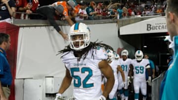 Nov 11, 2013; Tampa, FL, USA; Miami Dolphins outside linebacker Philip Wheeler (52) and teammates run out of the tunnel prior to the game against the Tampa Bay Buccaneers at Raymond James Stadium. Mandatory Credit: Kim Klement-USA TODAY Sports