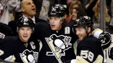 Jan 23, 2016; Pittsburgh, PA, USA; Pittsburgh Penguins center Sidney Crosby (87) and center Evgeni Malkin (71) and defenseman Kris Letang (58) celebrate after a gaol by Malkin against the Vancouver Canucks during the second period at the CONSOL Energy Center. Mandatory Credit: Charles LeClaire-USA TODAY Sports