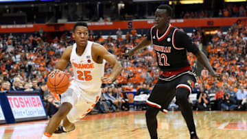 SYRACUSE, NY - FEBRUARY 13: Tyus Battle #25 of the Syracuse Orange drives to the basket against the defense of Deng Adel #22 of the Louisville Cardinals during the first half at the Carrier Dome on February 13, 2017 in Syracuse, New York. (Photo by Rich Barnes/Getty Images)