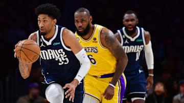 Jan 12, 2023; Los Angeles, California, USA; Dallas Mavericks forward Christian Wood (35) moves the ball up court ahead of Los Angeles Lakers forward LeBron James (6) during the first half at Crypto.com Arena. Mandatory Credit: Gary A. Vasquez-USA TODAY Sports