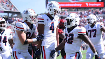 Sep 3, 2022; San Diego, California, USA; Arizona Wildcats running back DJ Williams (32) celebrates with tight end Tanner McLachlan (84) and wide receiver Tetairoa McMillan (4) after scoring a touchdown against the San Diego State Aztecs during the second half at Snapdragon Stadium. Mandatory Credit: Orlando Ramirez-USA TODAY Sports