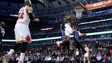 Apr 14, 2014; Chicago, IL, USA; Chicago Bulls guard Tony Snell (20) is defended by Orlando Magic center Dewayne Dedmon (3) and forward Andrew Nicholson (44) during the second half at the United Center. Chicago defeats Orlando 108-95. Mandatory Credit: Mike DiNovo-USA TODAY Sports