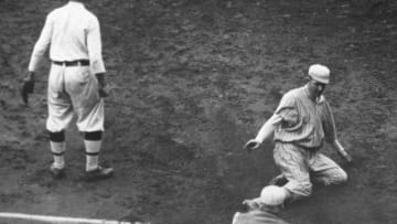 PHILADELPHIA - OCTOBER 8, 1913. Philadelphia Athletics third baseman Frank Baker waits for the ball during the tenth inning of game of two of the 1913 World Series in Philly on October 8th, as Giants' pitcher Christy Mathewson slides safely into third. Matty will soon score the winning run. (Photo by Mark Rucker/Transcendental Graphics, Getty Images)