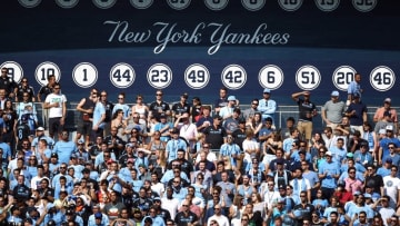 Aug 29, 2015; New York, NY, USA; New York City FC fans cheer in front of the retired numbers of the New York Yankees during the first half against the Columbus Crew SC at Yankee Stadium. Mandatory Credit: Danny Wild-USA TODAY Sports