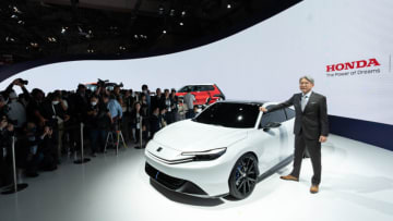TOKYO, JAPAN - OCTOBER 25: Honda Motor Co. CEO Toshihiro Mibe poses with the company's Prelude Concept electric vehicle during the Japan Mobility Show at Tokyo Big Sight in Tokyo, Japan on October 25, 2023. The show, formally known as the Tokyo Motor Show, will be held until November 05. (Photo by Tomohiro Ohsumi/Getty Images)