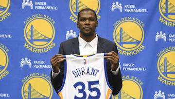Jul 7, 2016; Oakland, CA, USA; Kevin Durant poses for a photo with his jersey during a press conference after signing with the Golden State Warriors at the Warriors Practice Facility. Mandatory Credit: Kyle Terada-USA TODAY Sports