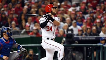 Oct 13, 2016; Washington, DC, USA; Washington Nationals right fielder Bryce Harper (34) hits a sacrifice fly during the third inning against the Los Angeles Dodgers during game five of the 2016 NLDS playoff baseball game at Nationals Park. Mandatory Credit: Brad Mills-USA TODAY Sports