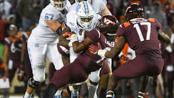 BLACKSBURG, VA - OCTOBER 19: Defensive back Khalil Ladler #9 of the Virginia Tech Hokies tackles running back Javonte Williams #25 of the North Carolina Tar Heels in the first overtime at Lane Stadium on October 19, 2019 in Blacksburg, Virginia. (Photo by Michael Shroyer/Getty Images)