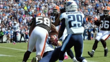 Oct 5, 2014; Nashville, TN, USA; Tennessee Titans quarterback Jake Locker (10) is hit by Cleveland Browns inside linebacker Chris Kirksey (58) after scoring a touchdown during the first half at LP Field. Mandatory Credit: Jim Brown-USA TODAY Sports