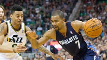 Dec 30, 2013; Salt Lake City, UT, USA; Charlotte Bobcats point guard Ramon Sessions (7) drives while defended by Utah Jazz point guard Diante Garrett (8) during the first half at EnergySolutions Arena. The Jazz won 83-80. Mandatory Credit: Russ Isabella-USA TODAY Sports