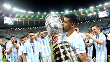 RIO DE JANEIRO, BRAZIL - JULY 10: Cristian Romero of Argentina lift and kiss the Conmebol Copa America Trophy after winning the Final of Copa America Brazil 2021 ,during the Final Match between Brazil and Argentina at Maracana Stadium on July 10, 2021 in Rio de Janeiro, Brazil. (Photo by MB Media/Getty Images)