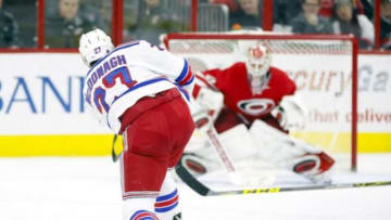 Jan 22, 2016; Raleigh, NC, USA; New York Rangers defensemen Ryan McDonagh (27) scores on his first period shot against Carolina Hurricanes goalie Eddie Lack (31) at PNC Arena. Mandatory Credit: James Guillory-USA TODAY Sports